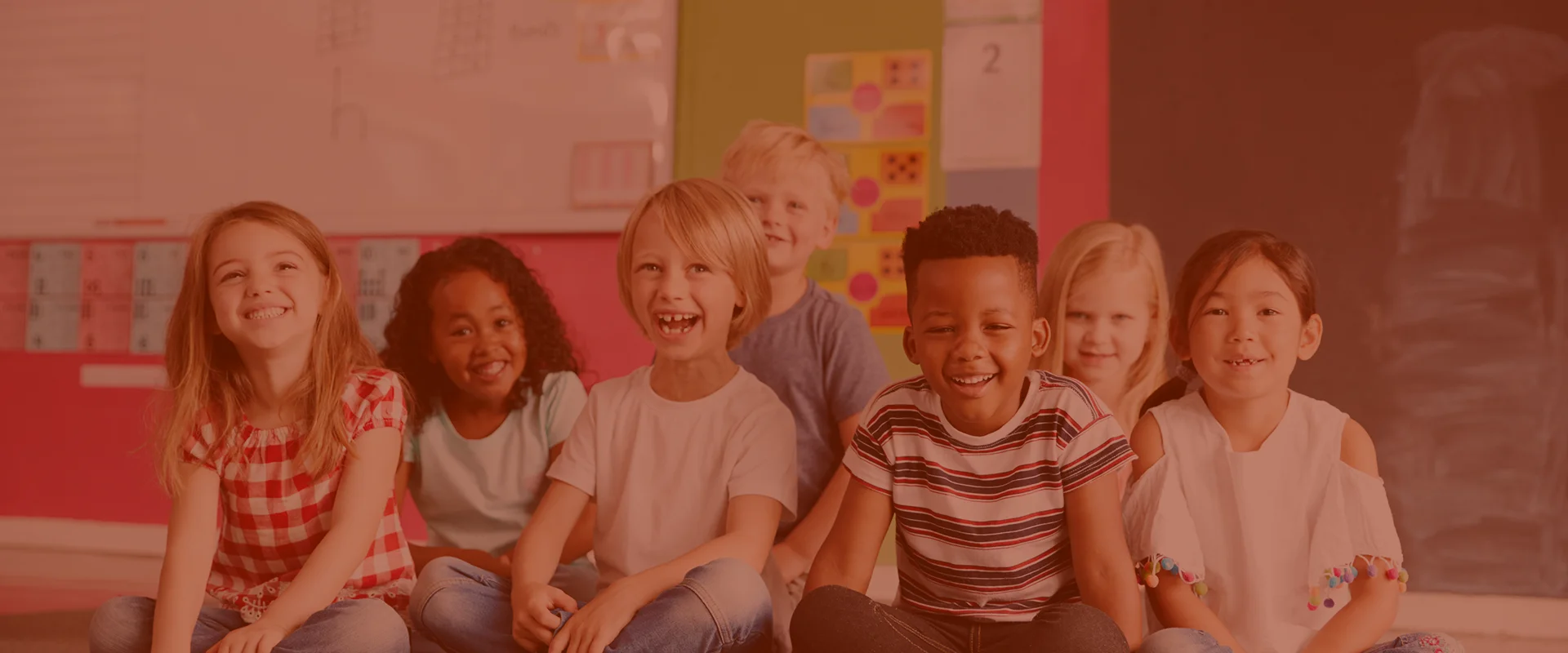 Group of diverse, happy children sitting together at a daycare